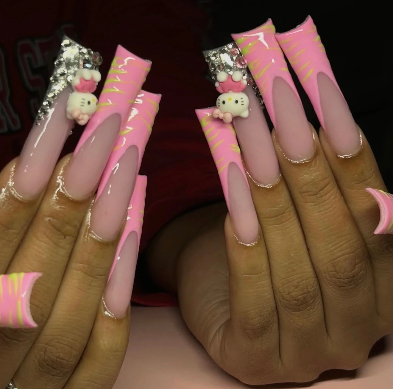 Extra-long pink character nails with charms and rhinestones