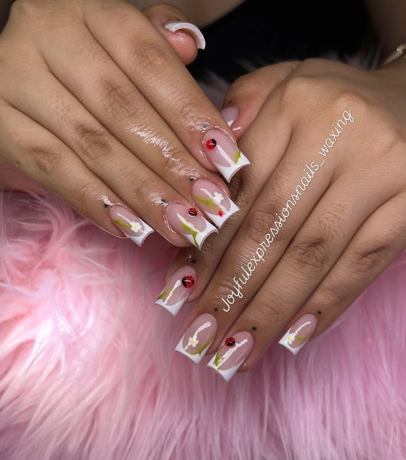 Short French nails with ladybugs, daisies and green stems