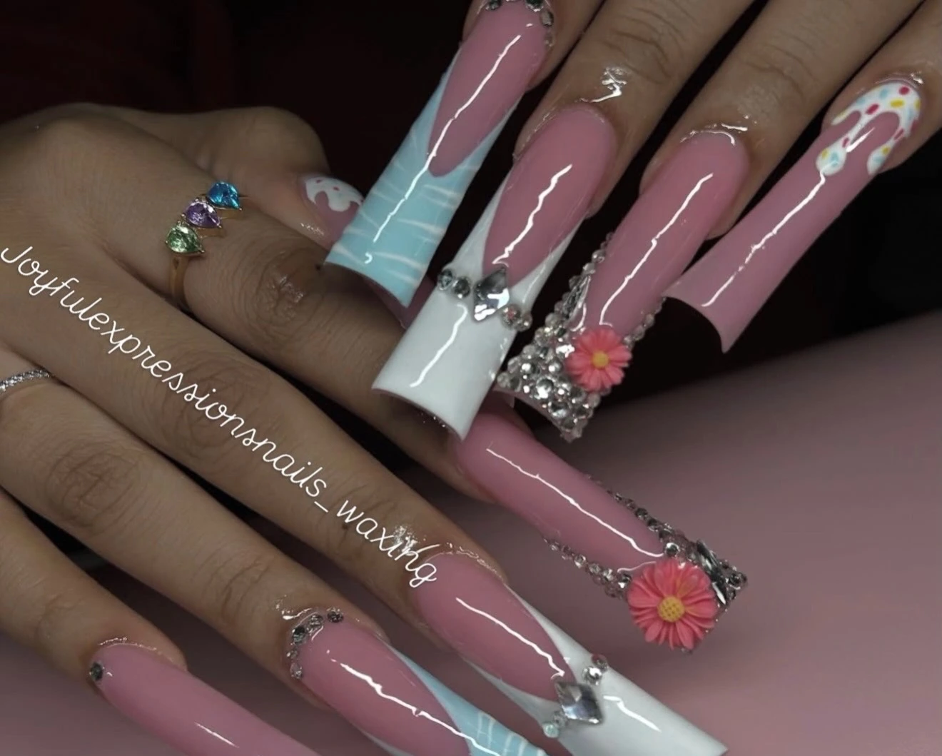 Long pink, blue and white nails with crystal and flower details