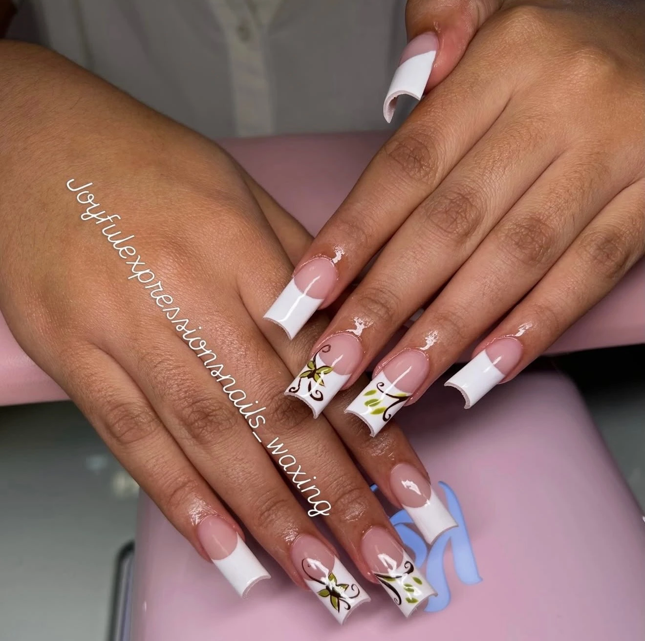 White French tips with delicate green and black floral details